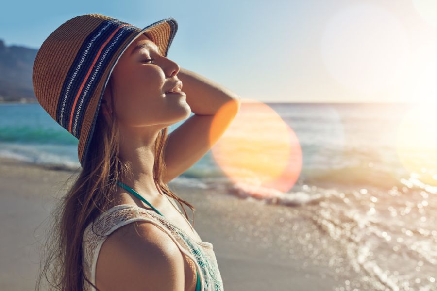 a lady on a beach in the sun after having skin treatments at sf aesthetics.