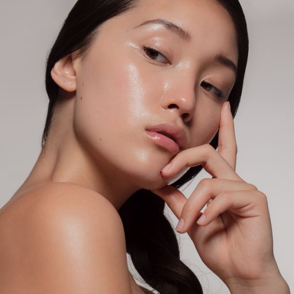 a lady looking to the left with very hydrated skin after having a skin booster.