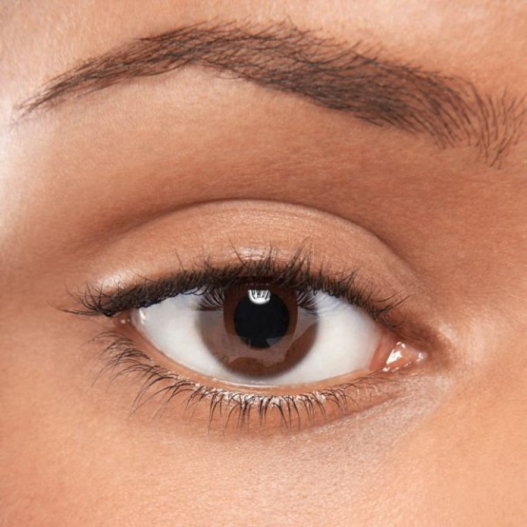 A close up of an eye and eyebrow. The iris colour is brown.
